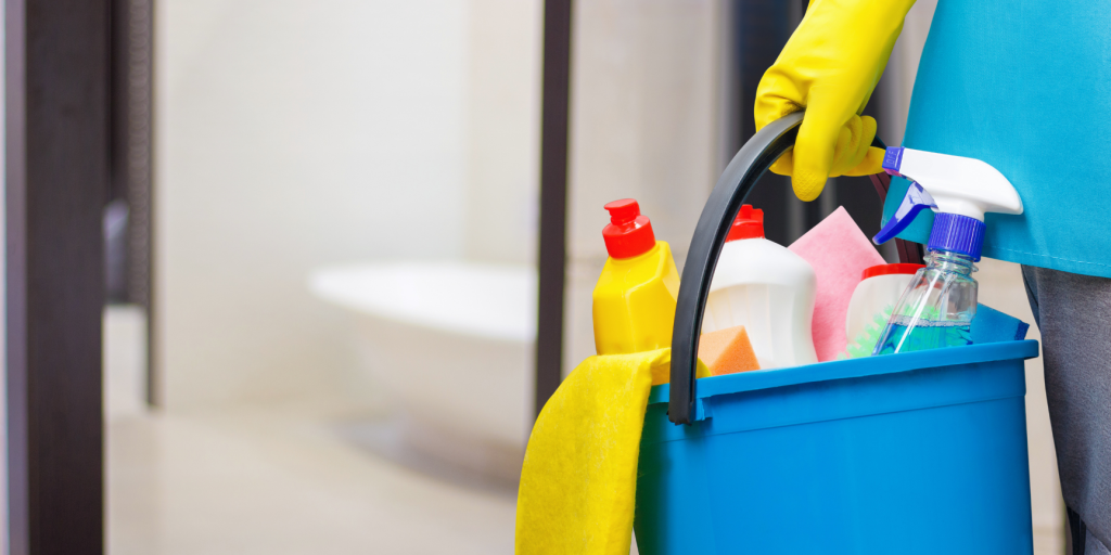 Office Deep Cleaning | Hand holding a bucket of cleaning products