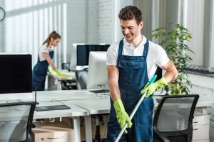 commercial office cleaning | man and woman cleaning an office