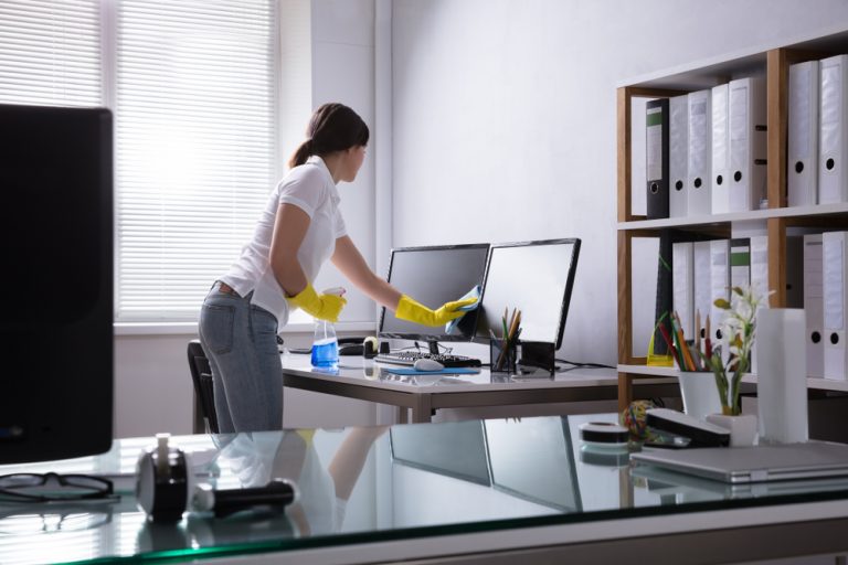 Commercial Office Cleaning Companies Near Me | Woman cleaning office desk