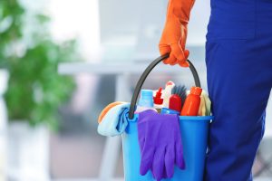 workplace cleanliness | person holding cleaning products