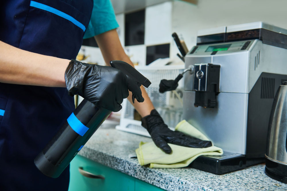 Office Cleaning Services Near Me | Person cleaning machine in kitchen