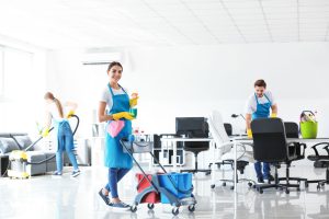 Office Cleaning Company | Lady holding cleaning products in an office