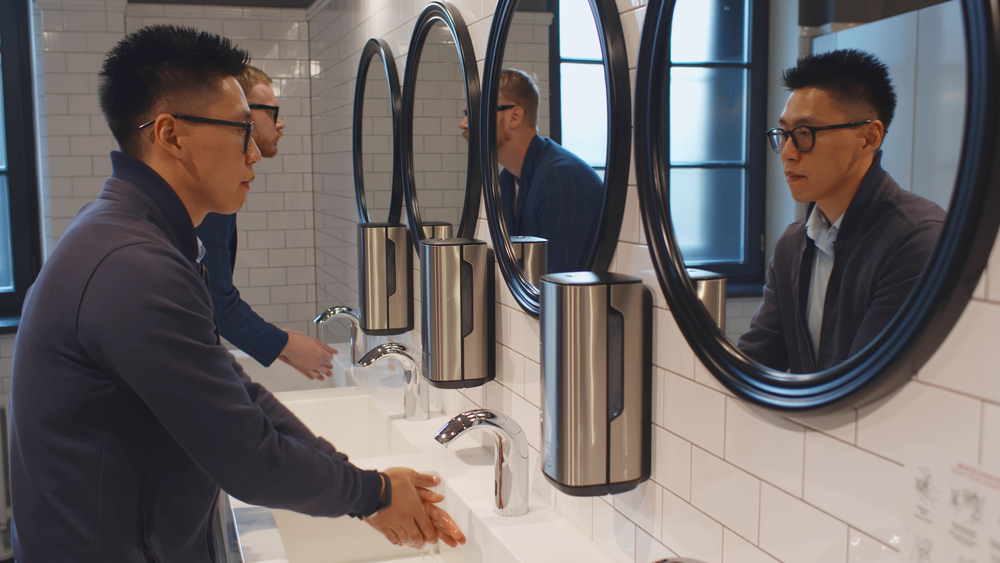 Washroom Hygiene Services | 2 men washing their hands in a work bathroom 