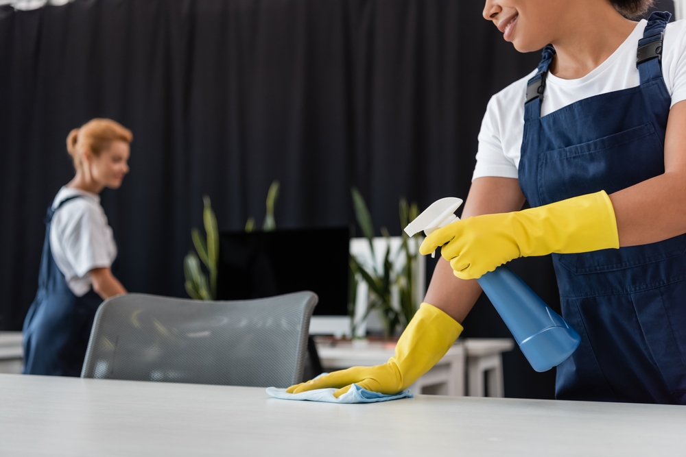 What Is Commercial Cleaning | two people cleaning desks in an office